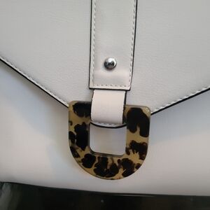 Zara, off-white crossbody bag with silver hardware detail, and tortoise closure.